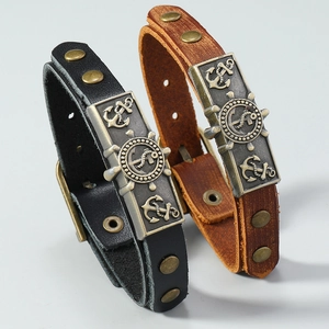 Close-up of vintage leather anchor bracelets with bronze metal plates and rivets