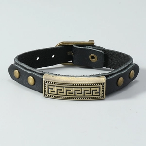 Detail of vintage black cowhide leather multi-layer bracelet with Greek key metal plate