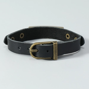 Macro view of black leather bracelet with antique bronze buckle and eyelet details