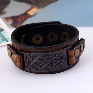 Vintage brown leather cuff bracelet for men featuring a Celtic knot metal plate and studs