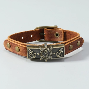 Retro nautical leather bracelet with bronze anchor and rudder charms on adjustable brown strap