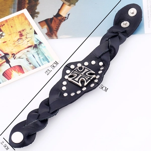 Punk black leather wide braided bracelet with metal cross and rivets on fashion background