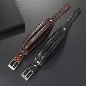 Detail view of adjustable wide leather bracelets in black and brown with metal buckles