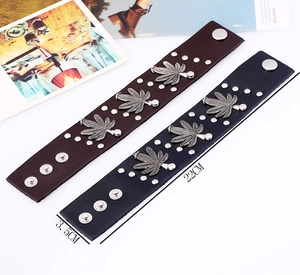 Punk style wide leather bracelet with maple leaf metal studs and adjustable rivets