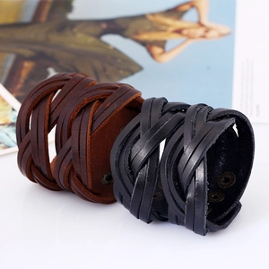 Detailed view of woven leather bracelets in black and brown with metal snap buttons