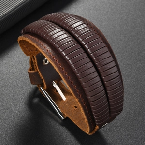 Detail of vintage brown leather bracelet showing textured layers and adjustable metal buckle