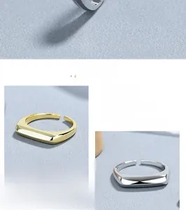 Detail view of S925 sterling silver stamp on polished gold and silver open rings
