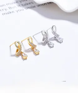 Macro shot of 925 silver crossover stud earrings with sparkling teardrop zircons