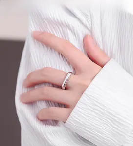 Close-up of a minimalist 925 silver open ring with a polished mirror finish on model