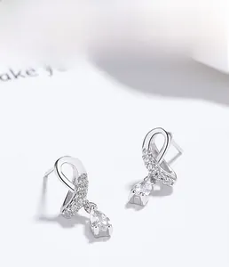 Detailed close-up of 925 sterling silver ribbon earrings with pear-cut cubic zirconia