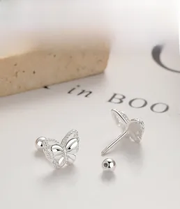 Macro shot of 925 sterling silver butterfly stud earrings with sparkling pavé details