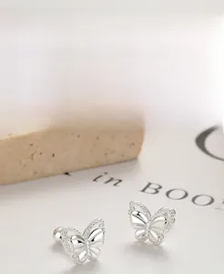 Close-up of S925 sterling silver butterfly stud earrings with hollowed polished finish