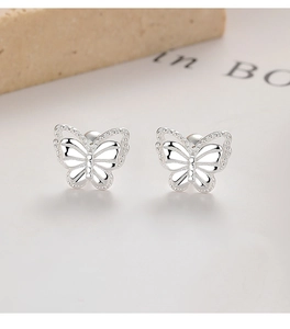 Detailed close-up of 925 sterling silver butterfly stud earrings with hollow dot wing pattern