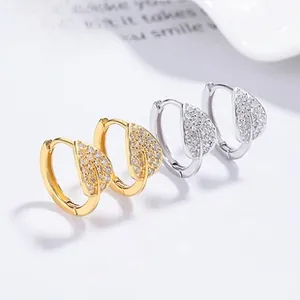 Detailed close-up of 925 sterling silver leaf hoop earrings with shimmering pavé cubic zirconia