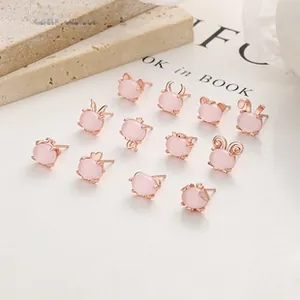 Detailed close-up of 12-piece rose gold stud earrings set featuring pink cat-eye motifs