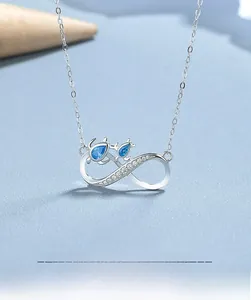 Macro shot of 925 sterling silver infinity necklace with sparkling blue teardrop crystals