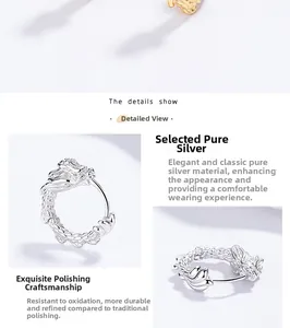 Detail of 925 sterling silver dragon hoop earrings with polished texture and relief