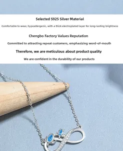 Macro detail of S925 silver infinity necklace with blue teardrop zircon stones