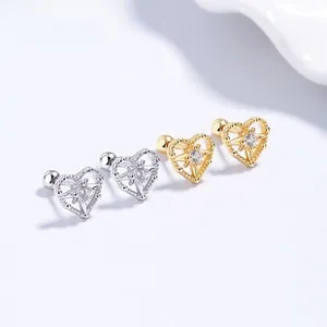 Macro detail of 925 silver heart stud earrings with starburst zircon and screw back
