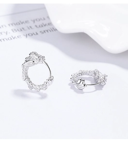 Close-up of 925 sterling silver dragon hoop earrings with detailed dragon scale texture