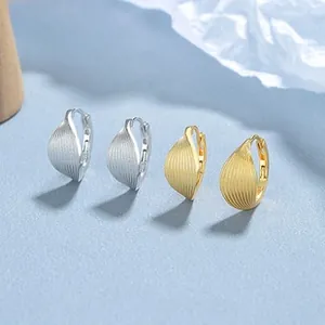 Detail view of 925 silver and gold leaf earrings with textured brushed finish surfaces