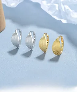 Detail of 925 sterling silver leaf hoop earrings with textured finish and S925 hallmark