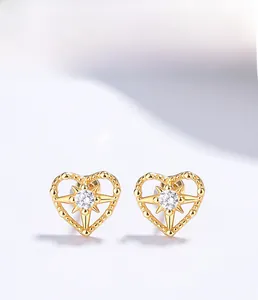 Macro detail of S925 sterling silver heart stud with gold plating and star zircon