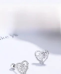 Detailed macro view of S925 sterling silver heart earrings with star-shaped zircon stone