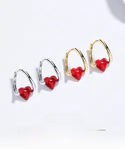 Detailed view of S925 sterling silver hoop earrings with red enamel heart pendants