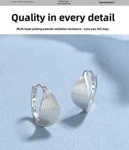 Detailed view of leaf-shaped S925 sterling silver hoop earrings with vertical brushed texture