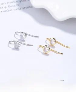 Gros plan détaillé des boucles d'oreilles cœur en argent 925 et or avec zircons