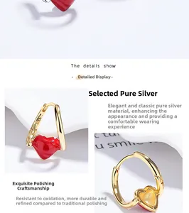 Detailed macro view of S925 sterling silver red heart earrings with polished gold finish