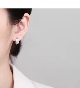 Close-up of 925 sterling silver leaf hoop earring with vertical stripe textured finish