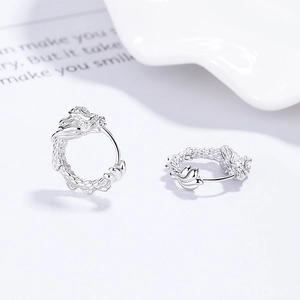 925 sterling silver dragon hoop earrings with detailed zodiac relief on white background