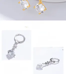 Gros plan sur des boucles d'oreilles créoles en argent 925 avec glands en zircone