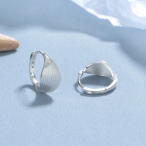 Elegant 925 sterling silver leaf hoop earrings with textured fan design on blue background