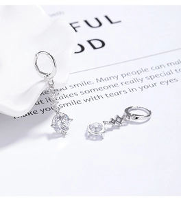 Détail de boucles d'oreilles créoles en argent S925 avec pampilles en zircon rond et poinçon