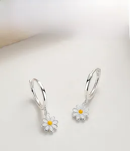 Close-up of S925 sterling silver daisy drop earrings with white enamel and yellow core
