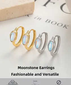 Macro detail of oval moonstone hoop earrings in S925 sterling silver and gold finish