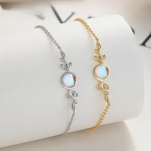 Detail of moonstone leaf bracelets in silver and gold plating on a jewelry stand