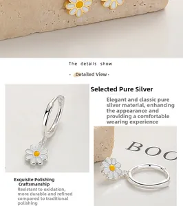 Close-up of S925 sterling silver daisy hoop earrings with white enamel petals