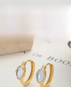 Detail of S925 silver gold-plated hoop earrings with blue-purple oval opal moonstones