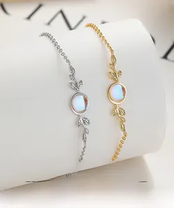 Macro shot of silver leaf bracelet with moonstone pendant on a white minimalist display