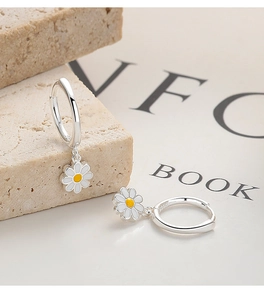 Detailed shot of S925 sterling silver stamp on small white daisy hoop earrings for women