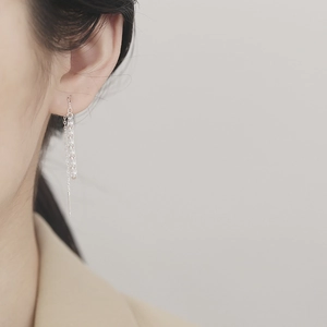 Elegant 925 sterling silver long tassel earrings worn by a model in a natural setting