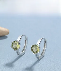 Detailed 45-degree angle of S925 sterling silver earrings with olive green zircon stones