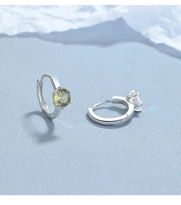 Detail of 925 sterling silver earrings showing S925 hallmark and olive green zircon