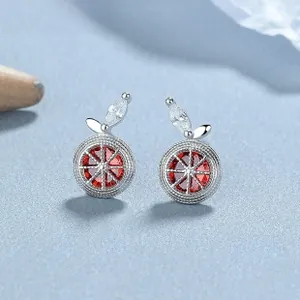 Macro shot of 925 silver orange slice stud earrings with red and clear cubic zirconia