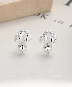 Macro detail of S925 sterling silver cabbage earrings with realistic textured leaf patterns