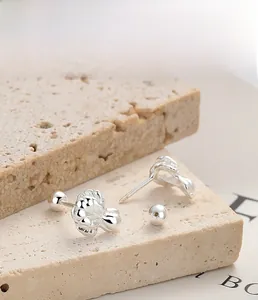 Detailed macro of S925 sterling silver flower stud earring with screw back on stone